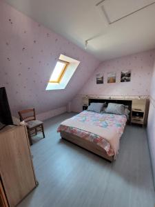 a bedroom with a large bed and a skylight at Chez Jo 