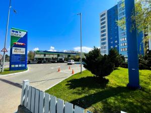 a parking lot with a car dealership and a building at Twins in Suceava