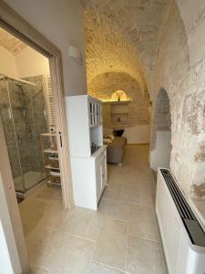 a large bathroom with a shower and a tile floor at La quiete in Ceglie Messapica