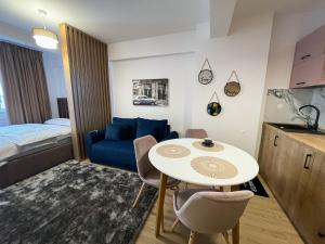 a small room with a table and a bed at Twins in Suceava
