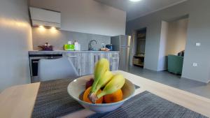 a bowl of fruit on a table in a kitchen at Jimmy's place in Artemida