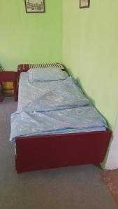 a small bed in a room with at Kućerak in Irig