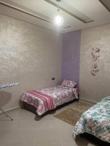 a bedroom with two beds in a room at LH résidence mezouar1 appartement 4 in Laayoune