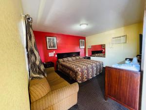 een hotelkamer met een bed en een bank bij Royal Palms Motel in New Orleans
