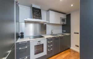 a kitchen with stainless steel appliances and a chalkboard on the wall at Sweet Inn - Paseo de Gracia - City Centre in Barcelona