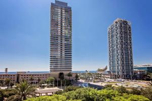 a view of two tall buildings in a city at Sweet Inn - Villa Olimpica Mediterranean in Barcelona