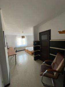 a room with a bedroom and a desk and a bed at Zajazd Korona in Łęgowo