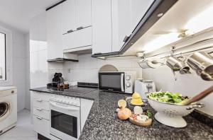 a kitchen with a bowl of food on a counter at Sweet Inn - Cosy Ciutadella in Barcelona