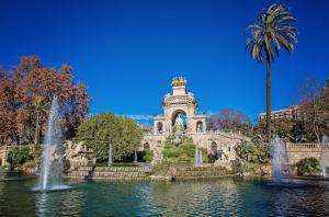 a building with a fountain in the middle of a pond at Sweet Inn - Cosy Ciutadella in Barcelona