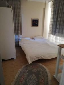 a bedroom with two beds and a window at Villa ARDEN in Kartepe