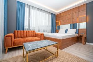 a hotel room with a bed and a couch at 216 Center Suite in Istanbul