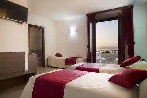 A bed or beds in a room at Resort Santa Maria Hotel