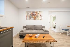 a living room with a couch and a table at Gabby's Place Downtown Core in Toronto