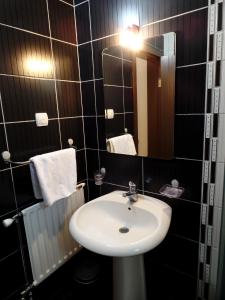 a bathroom with a sink and a mirror at Villa MILSA Half Board & Pool in Soko Banja +23 photos