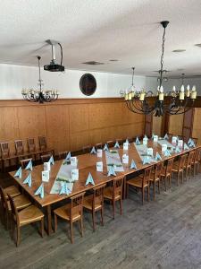 a long table in a room with chairs at Gasthof zum Greif in Leoben