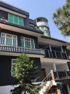 a building with a tree in front of it at SWAT HILL VIEW RESORT- only for families in Swat