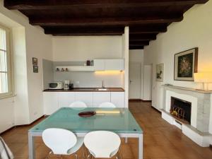 a living room with a table and chairs and a fireplace at Villa Lina in Lezzeno +19 photos