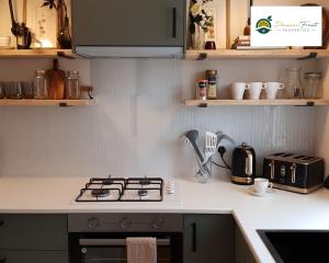 a kitchen with a stove and a counter top at 2 Bedroom House In Leeds With Free Wi-Fi and Parking 24 WAL in Beeston Hill