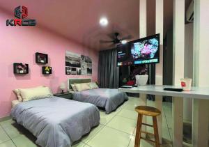 a room with two beds and a desk with a tv at KRCB Suite - Evo Mall Bandar Baru Bangi in Kampong Sungai Ramal Dalam