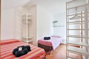 a bedroom with two beds and a ladder in it at Isola Blu, Jacuzzi & Pool by DomusAway in Porto San Paolo