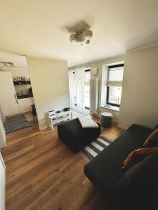 a living room with a couch and a table at Seaside_albatross in Ķesterciems