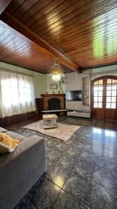 a living room with a couch and a fireplace at Casa Ipê in Monte Verde
