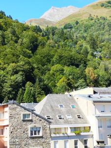 une vue sur un bâtiment avec une montagne en arrière-plan dans l'établissement appartement cosy hyper centre de Cauterets, à Cauterets