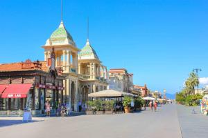 a street in a town with a building with turrets at Verahouse in Viareggio