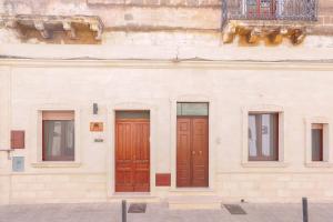 two doors on the side of a building at Le tre zie B&B in Manduria