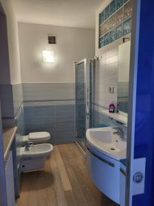 La salle de bains est pourvue de toilettes, d'un lavabo et d'une douche. dans l'établissement CASA VACANZE RELAX, à Riva di Solto