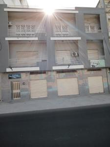 a building with gates on the side of it at Chambres d'hôte centre ville in Dakar