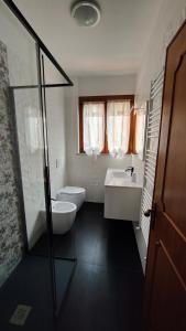 a bathroom with a toilet and a sink and a shower at La Casa fra gli ulivi in Lerici