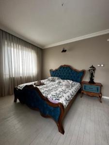 a bedroom with a large bed and a table at İsra Suit in Trabzon