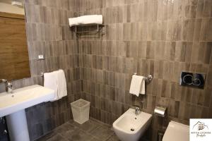 a bathroom with a sink and a toilet at Antica Locanda Bonfiglio in Busana