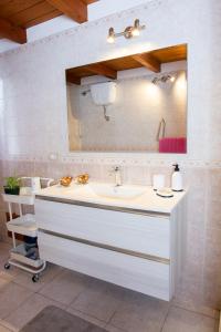 a bathroom with a sink and a mirror at Colombohouse87 in Quartu SantʼElena