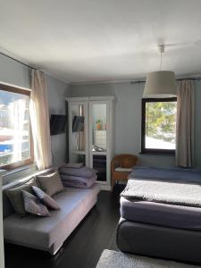 a bedroom with two beds and a couch and a window at Bergbach in Ramsau