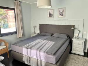 a bedroom with a bed and a lamp and a window at Bergbach in Ramsau