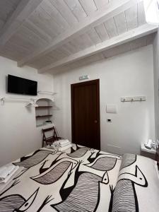 a bedroom with a bed with a black and white blanket at Borgo degli Svevi rooms in Bari
