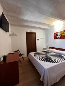 a bedroom with a bed and a flat screen tv at Borgo degli Svevi rooms in Bari +16 photos