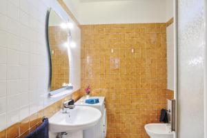 a bathroom with a sink and a mirror at Isola Blu, Jacuzzi & Pool by DomusAway in Porto San Paolo +19 photos