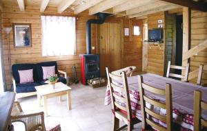 a living room with a table and a stove at 2 Bedroom Nice Home In Saulxures in Saulxures