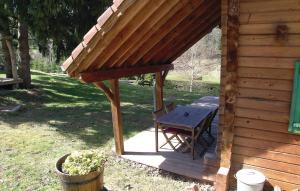 a wooden porch with a picnic table next to a cabin at 2 Bedroom Awesome Home In Saulxures in Saulxures +10 photos