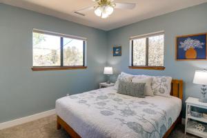 a bedroom with a bed and two windows at Putting Green and Patio Central Prescott Home in Prescott