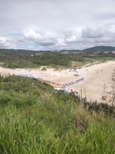 una playa con gente en la arena y la hierba en casatemporada05, en Cabo Frío