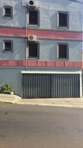 a building with a gate on the side of a street at HOTEL CENTER Ribeirão in Ribeirão Preto