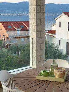 einen Tisch mit einem Glas auf einem Tablett auf einem Balkon in der Unterkunft Apartments Belmat in Trogir
