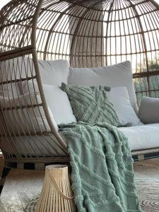 a hammock chair with a green blanket on it at Apartments Belmat in Trogir
