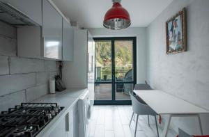 a kitchen with white counters and a stove top oven at Reef Terrace Apartments in Yaremche
