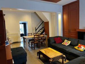 a living room with a couch and a table at citesteloi in Friville-Escarbotin