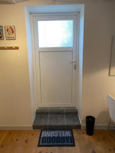 a door with a window and a mat in front of it at Apt17 - Guest house just outside of Billund - rural and quiet surroundings in Billund +15 photos